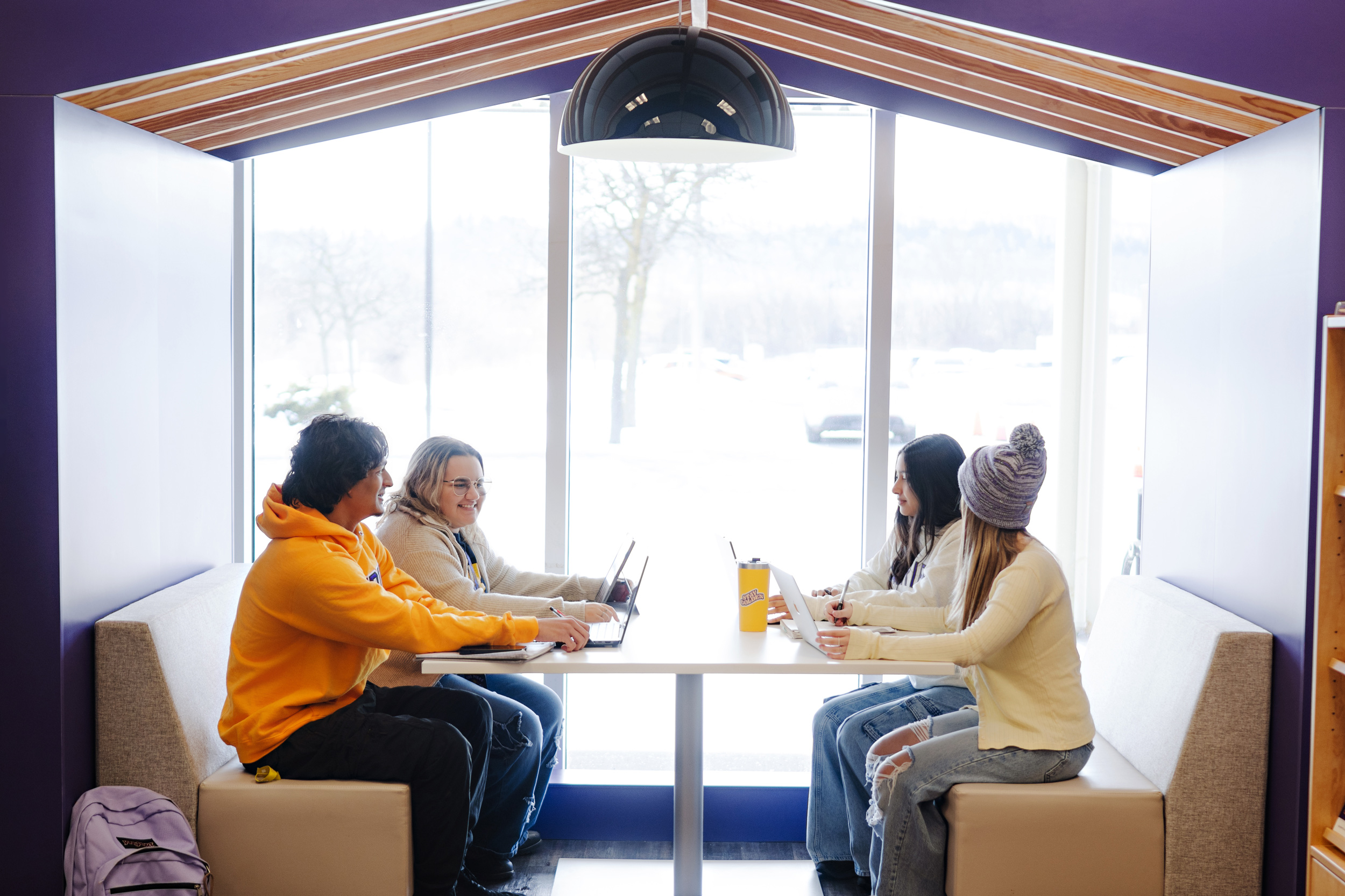 Four students sitting in a study nook