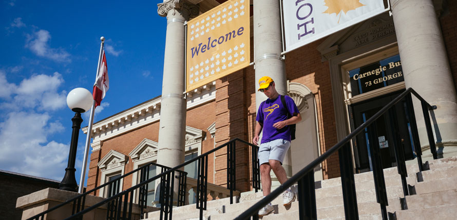 Students walks down Carnegie Building steps