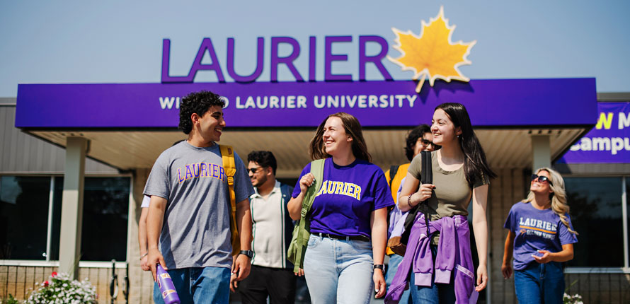 Milton students walk outside campus building