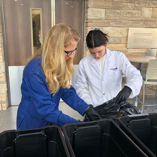 Gena Braun works with students on lab disposal