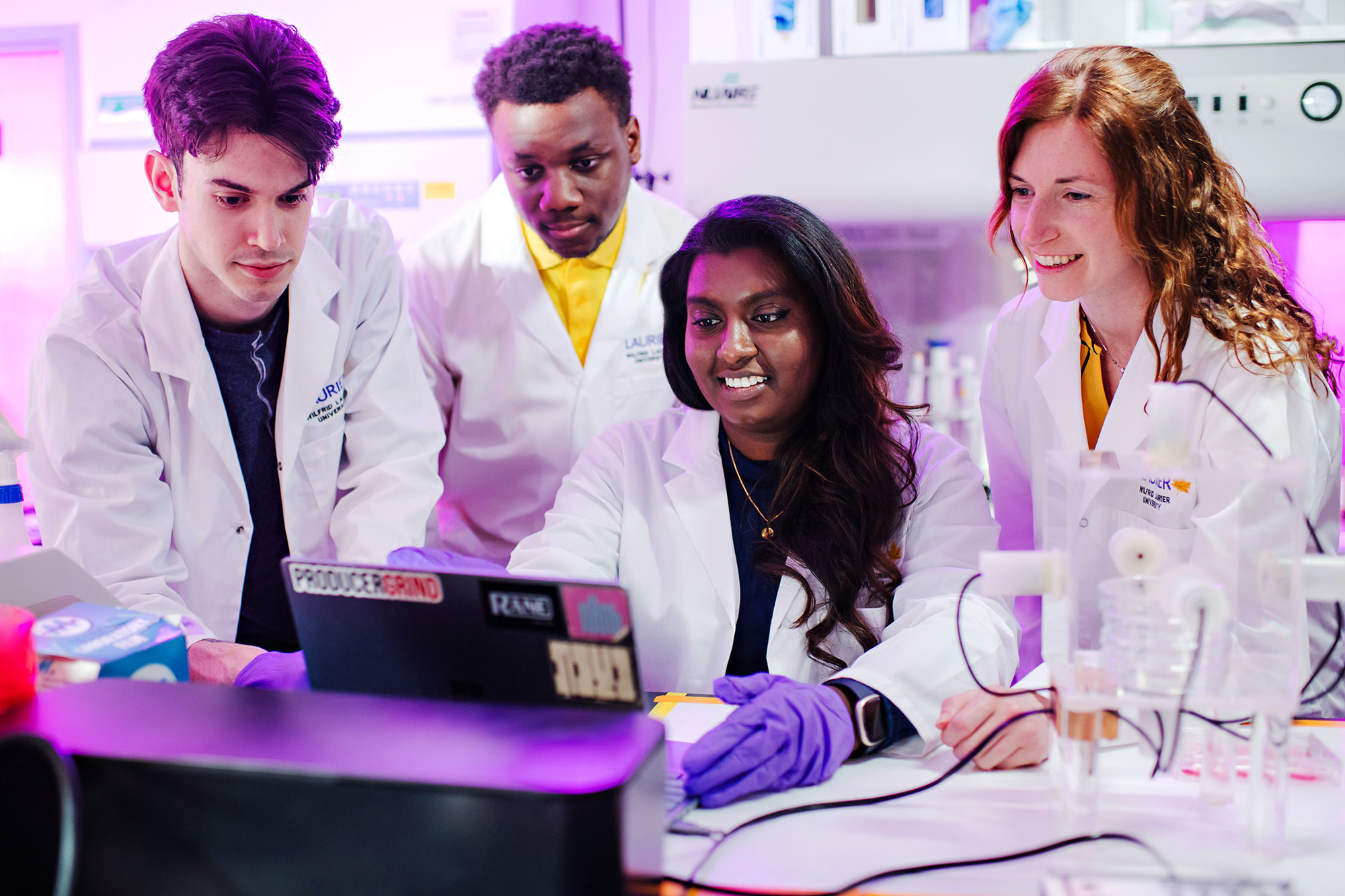 researcher with students in lab
