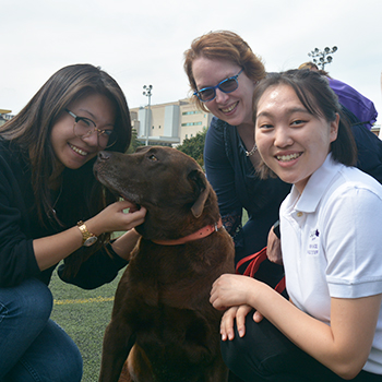 Deb with her dog and students