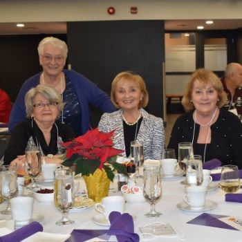 Four women at the retirees dinner