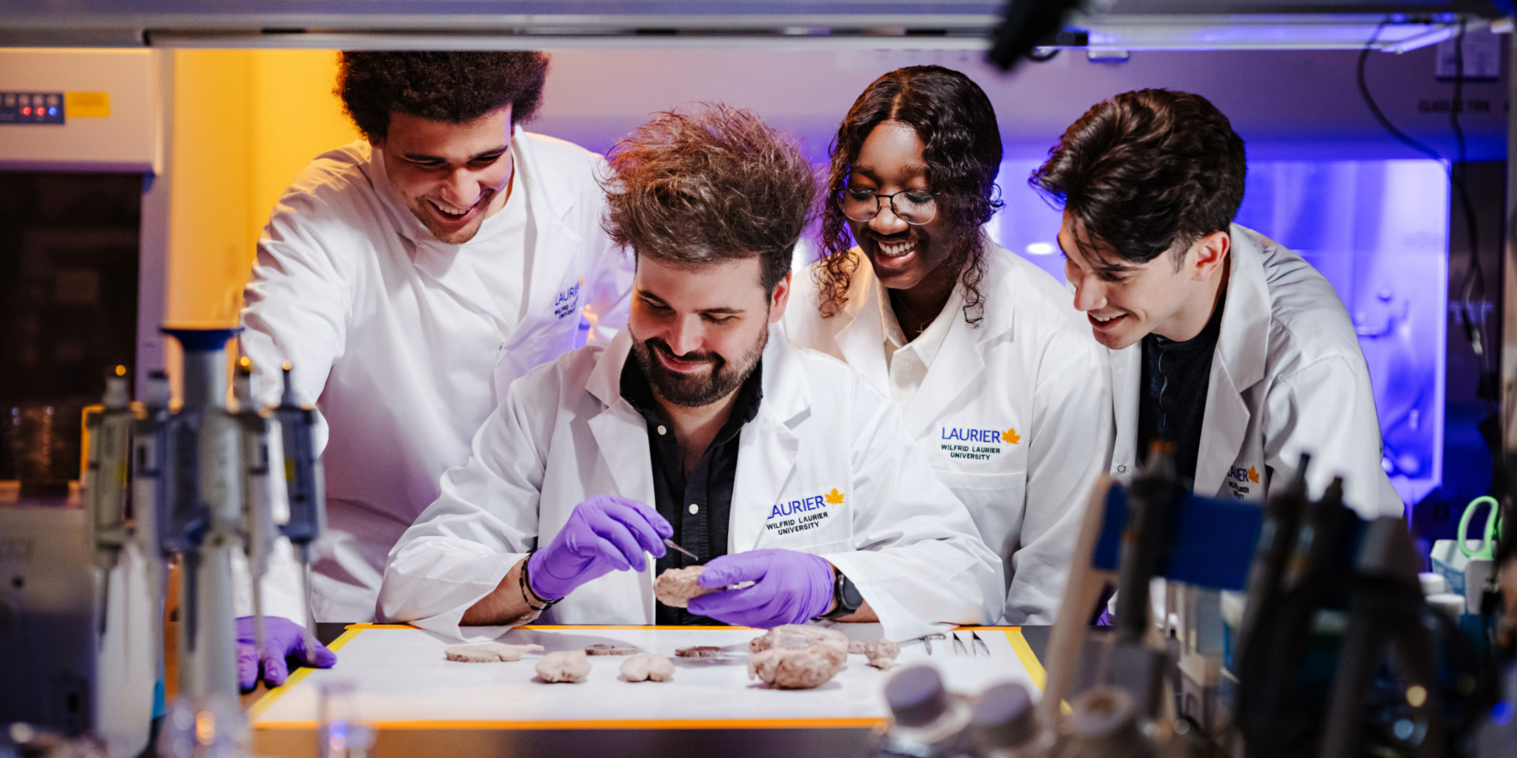 researcher with students in lab