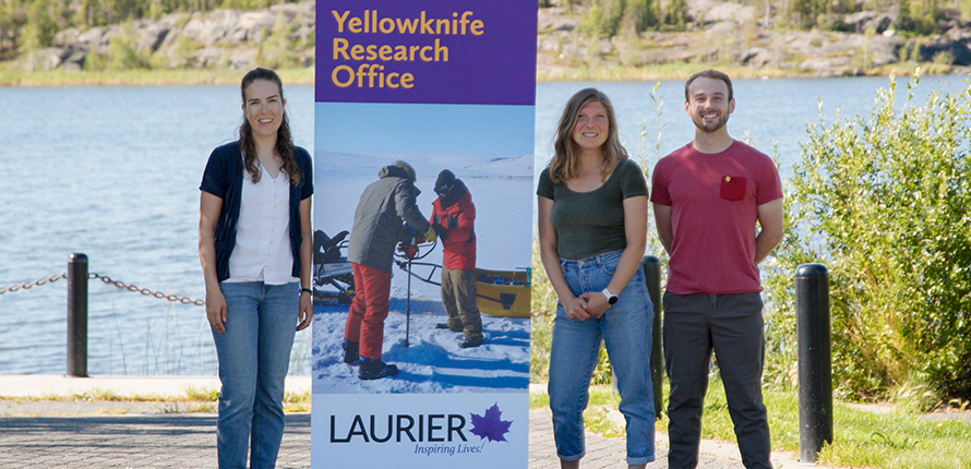 Laurier staff standing in front of lake in Yellowknife