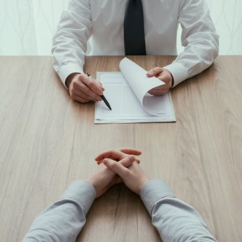 Hands on table during job interview