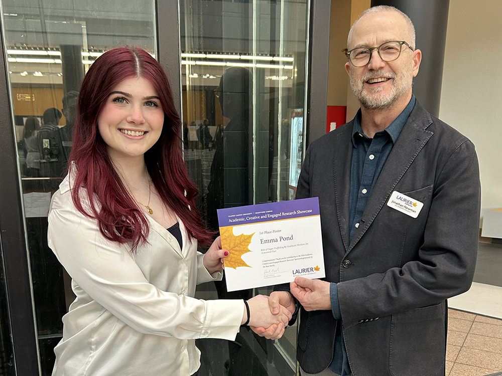 Emma Pond receives her ACERS certificate from Jonathan Newman