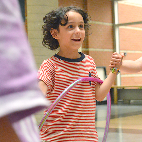 Camper at BrainWorx using hula hoop'