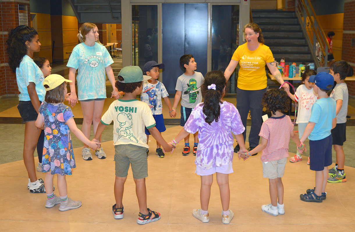 Campers holding hands in circle at BrainWorx