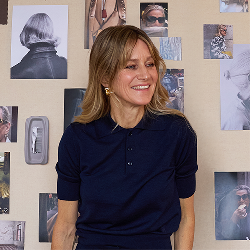 Designer Jenny Bird stands in front of an inspiration wall
