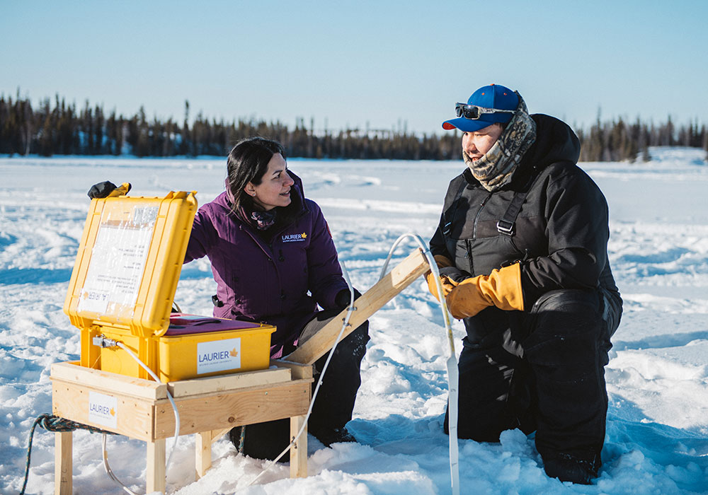 Homa Kheyrollah Pour examining an ice sensor with Chase Lockhart