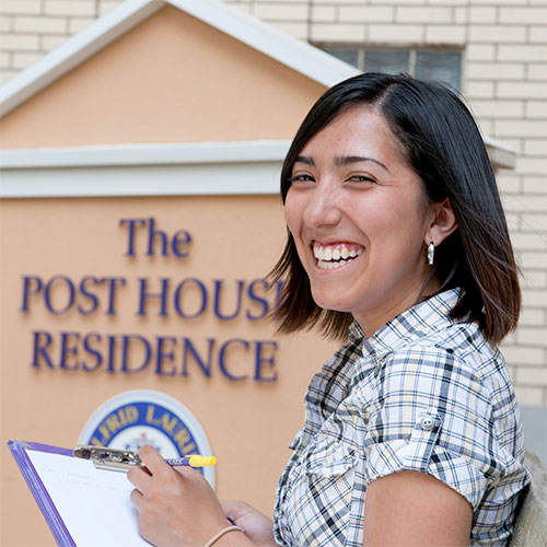 Woman in front of Post House Residence