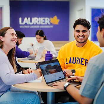 three students sitting inside at laurier milton