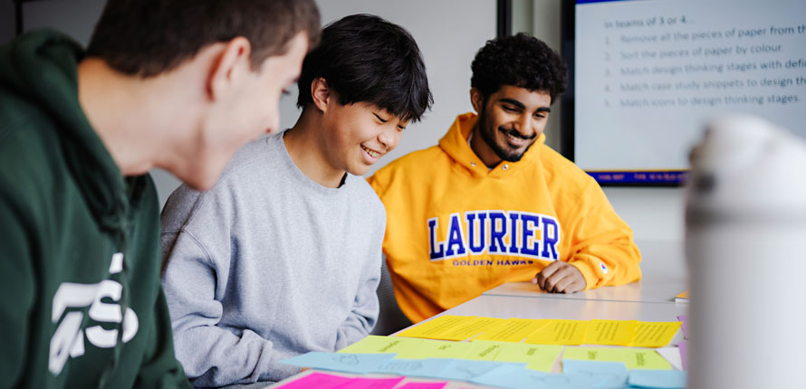students look at sticky notes in class