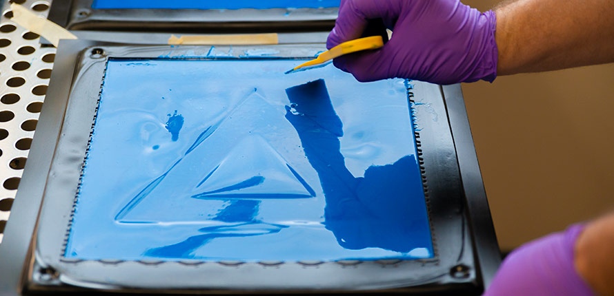 Image of blue liquid compound setting in a molded tray.