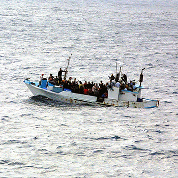 Boat in water full of immigrants