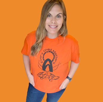 Maggie Allan, wearing the shirt she designed for Orange Shirt Day