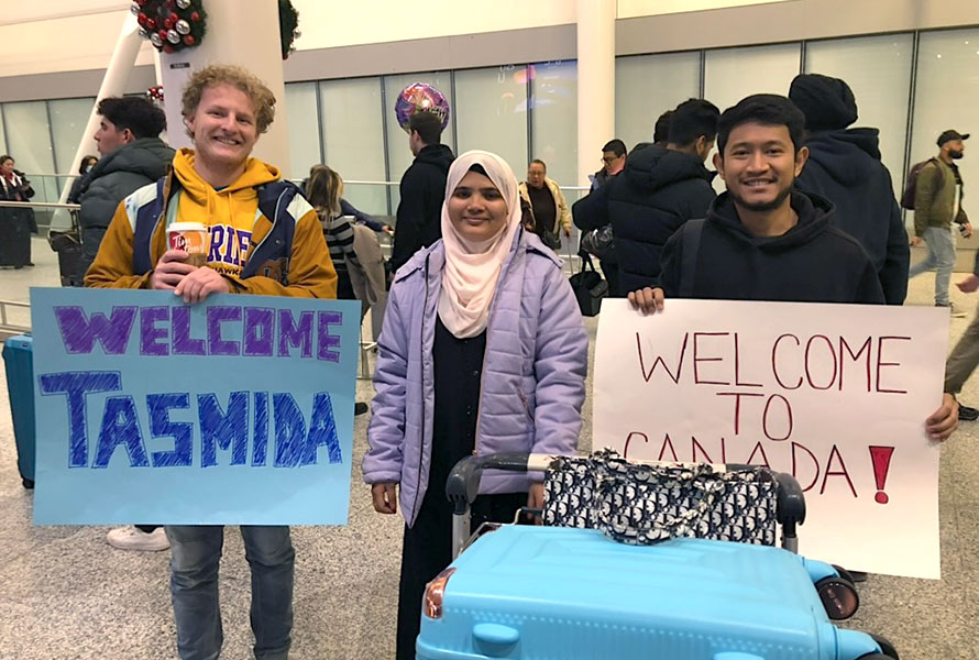 ISOW student being welcomed at airport with signs