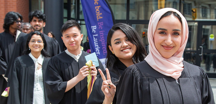 Brantford campus graduates stand outside Laurier's One Market building