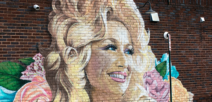 Dolly Parton mural on brick wall