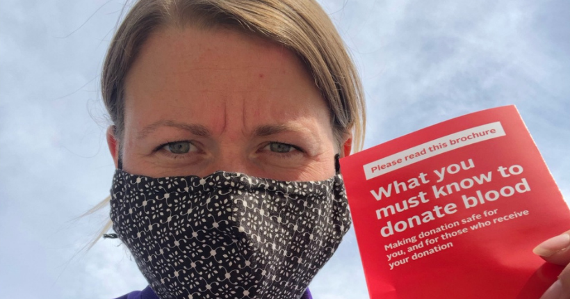 woman holding a pamphlet about blood donations